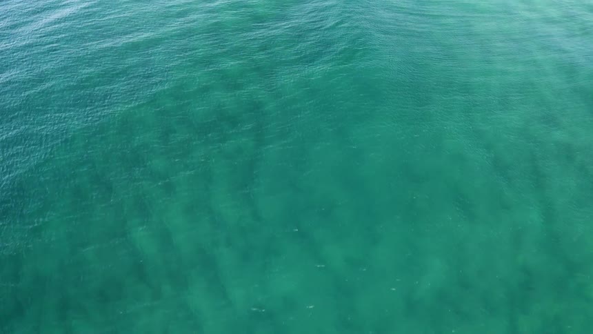 Aerial view of ocean water is displayed
