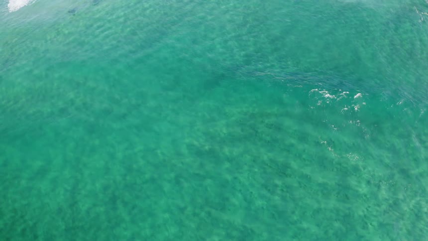 Aerial view of ocean water in the daytime is displayed