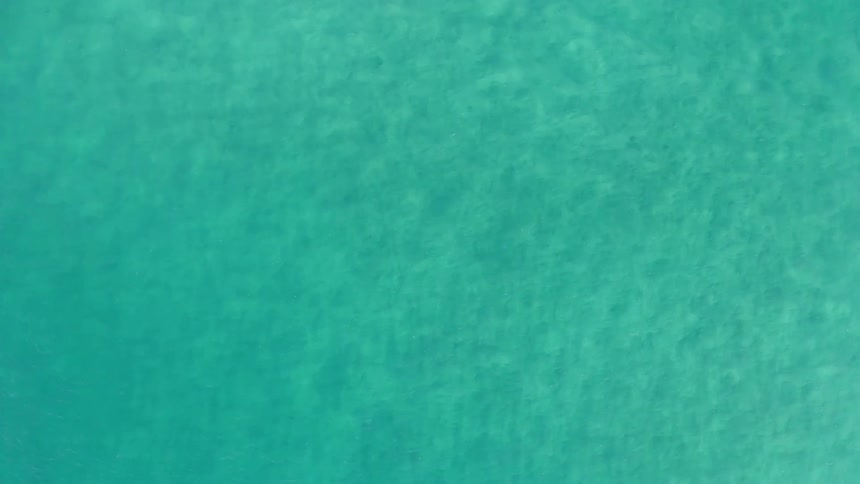 Aerial view of ocean water is displayed