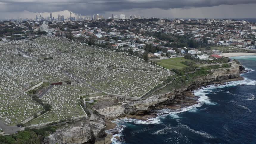 Aerial view of the cemetery next to the cliffs on a small coastal town