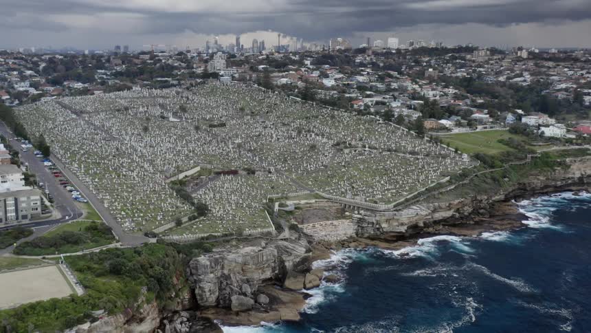 A massive cemetery on a cliff overlooking the ocean on a cloudy day