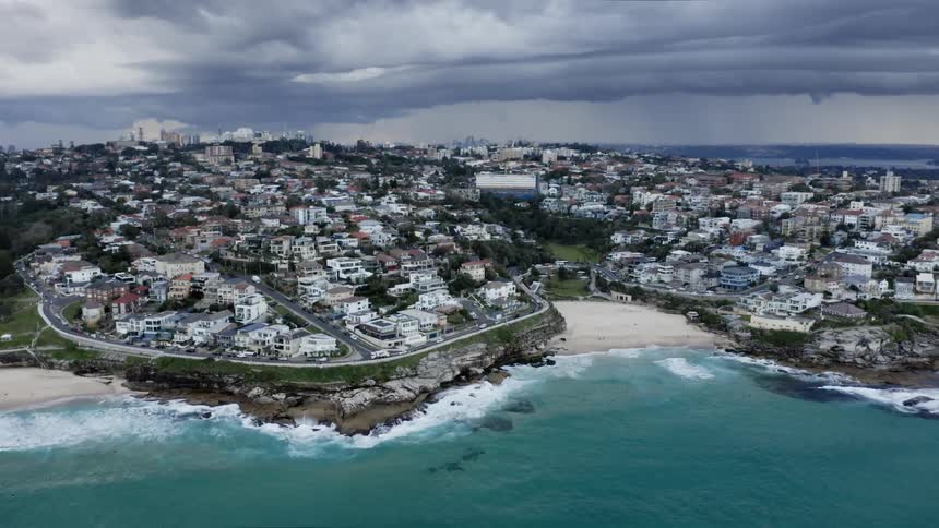 Aerial view of a coastal city and dark clouds