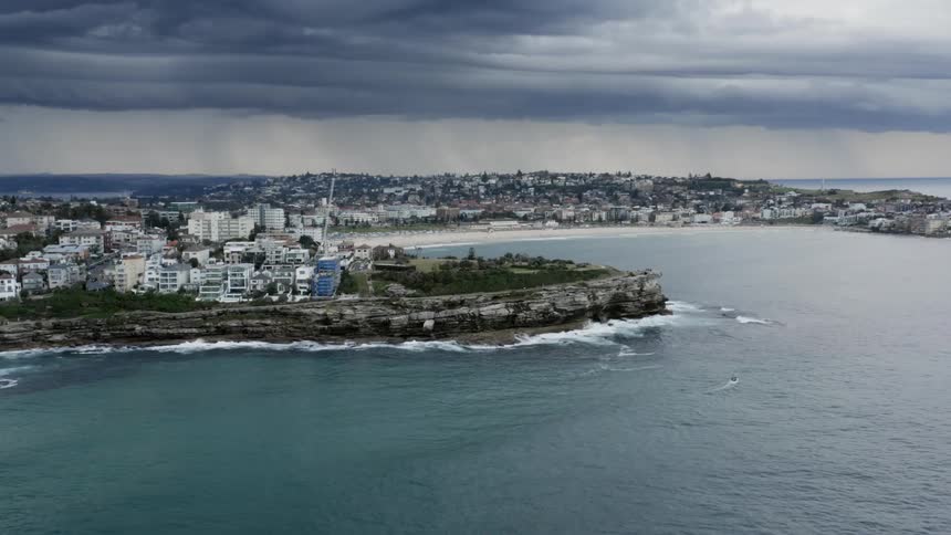 Aerial view of a cliff town with a rocky promontory overlooking the bay