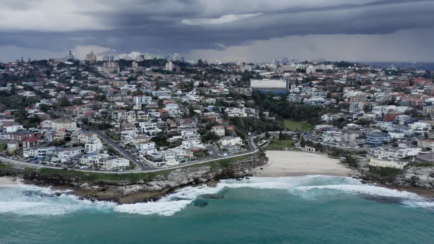 Aerial view of a downtown city next to the beach is displayed