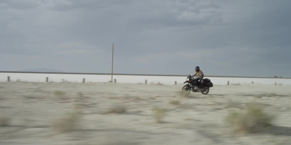 Someone rides a bike through the desert