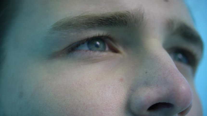 A close up view of a mans face is displayed