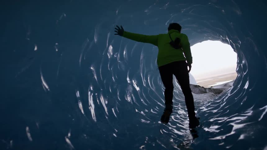 A person is walking through an arctic area