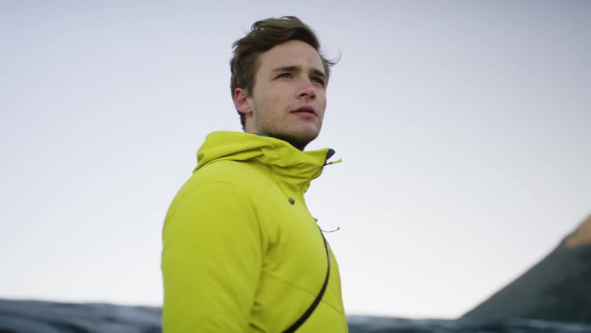 A man standing at the top of a mountain