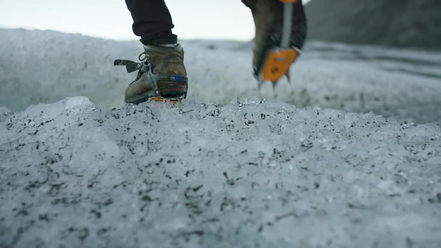 A person is hiking through an arctic are