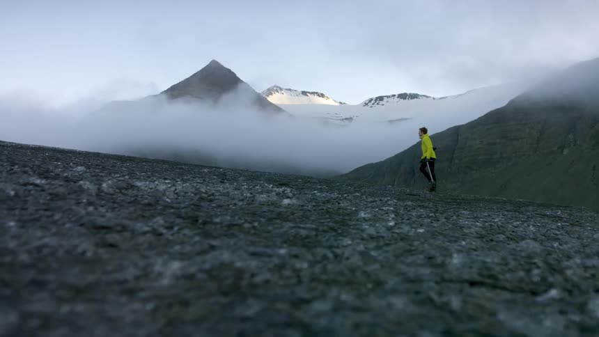 A person is hiking outdoors near a mountain
