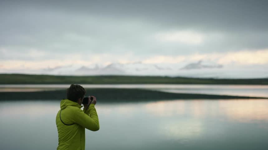 A man is taking photos of the horizon