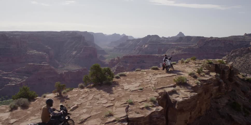 A person rides a bike up a rocky cliff