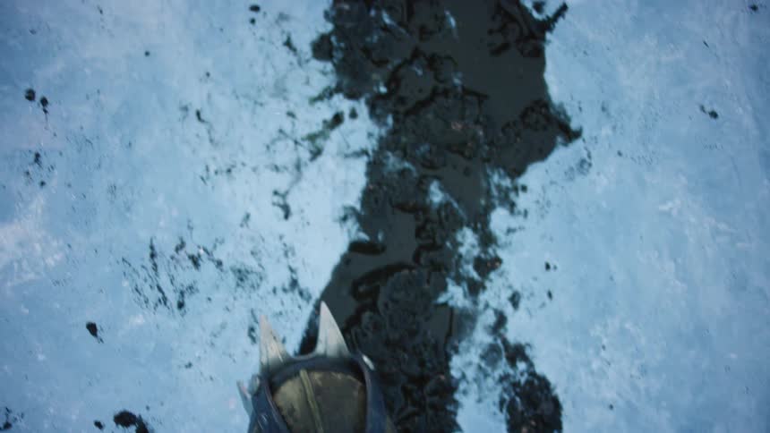 A person walking on ice in shoes with spikes on them