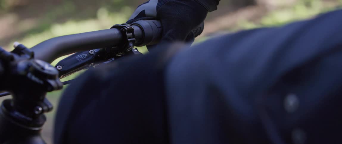 A person is riding his mountain bike on the trail