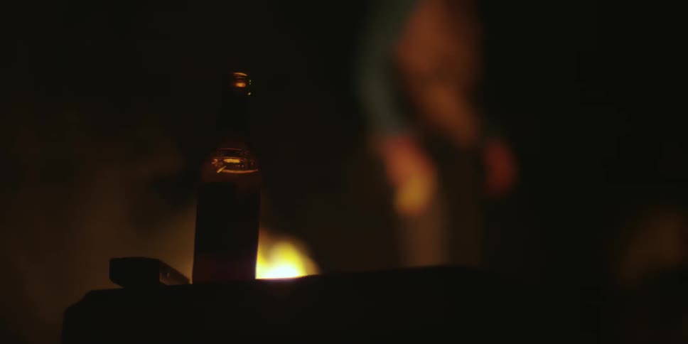 A man walking away from a bonfire