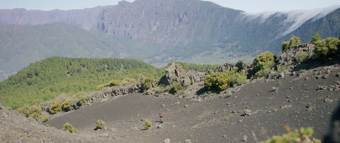A man rides his mountain bike down the hill