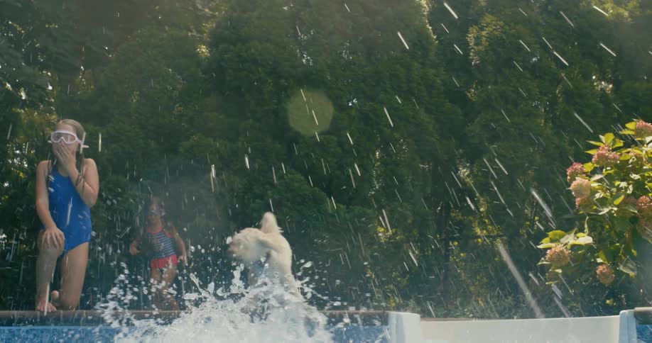 A young girl jumps into a swimming pool while other children watch