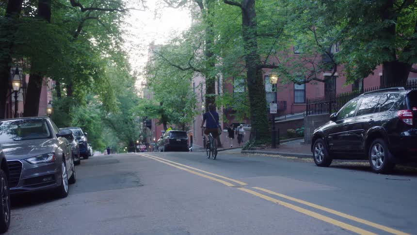 A man rides his bicycle down the street