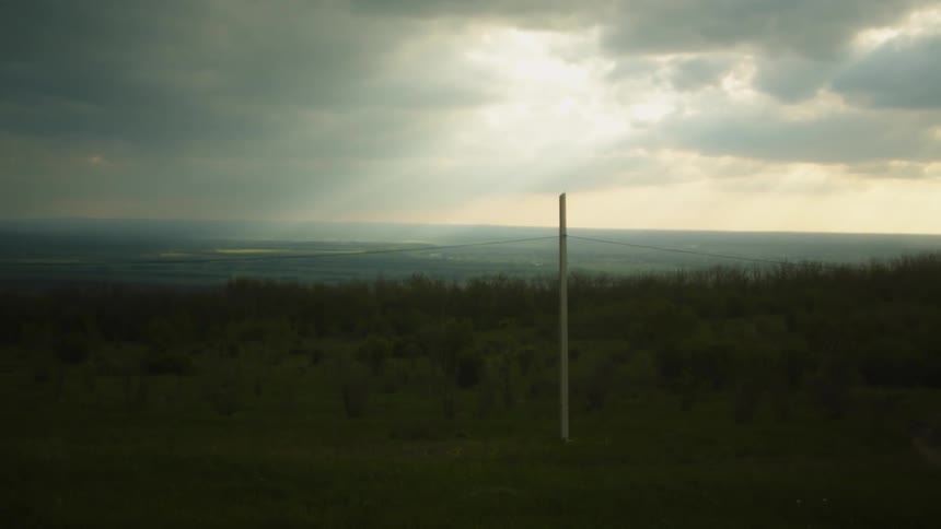 The sun is setting in the horizon of a rural area