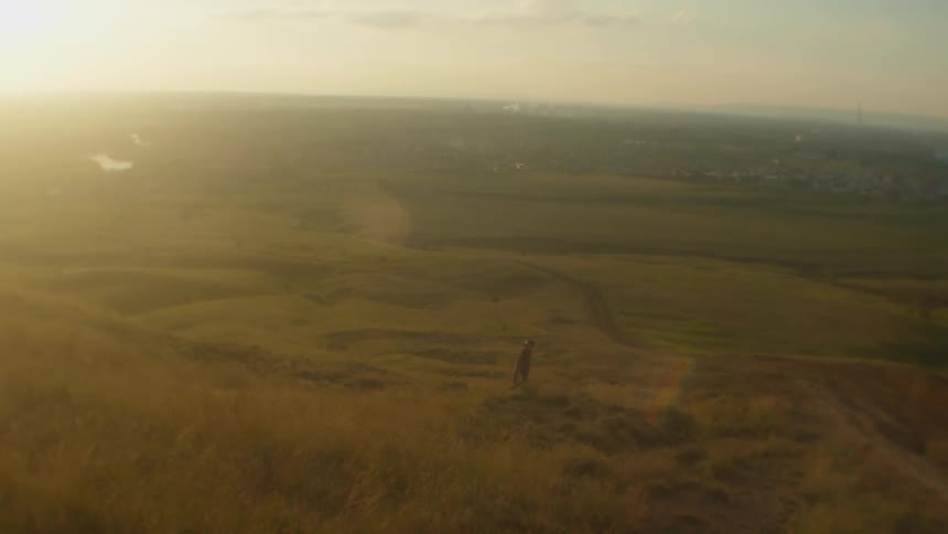 A person is hiking through a rural area