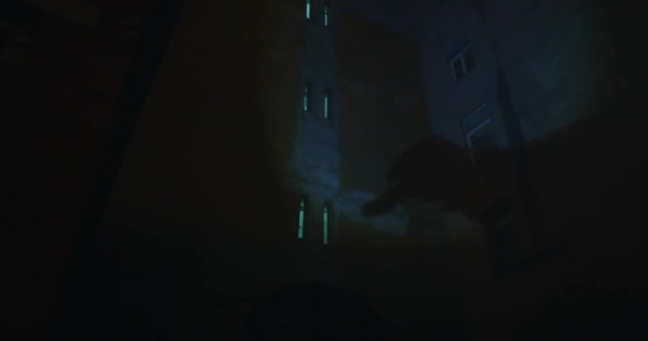The shadow of a hand is displayed on a wall