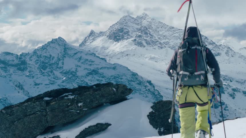 A skier walking at the top of a mountain