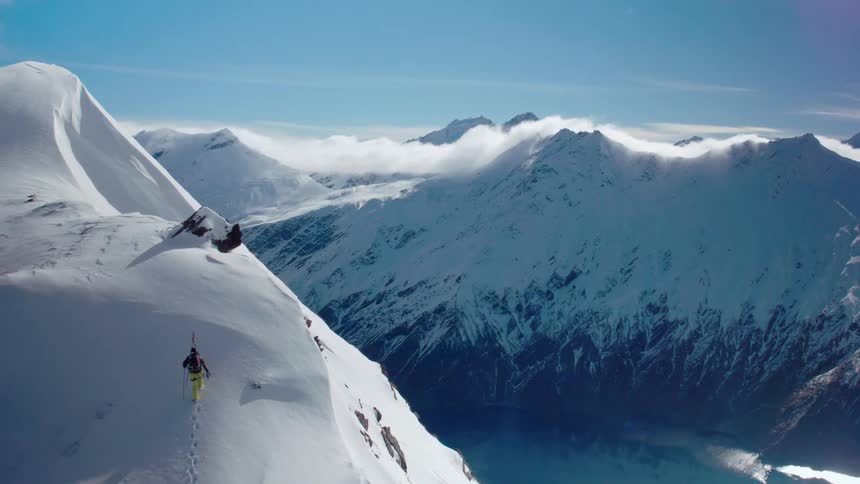 A person is hiking up the mountain side