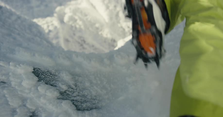 A person is hiking up the snow covered mountain