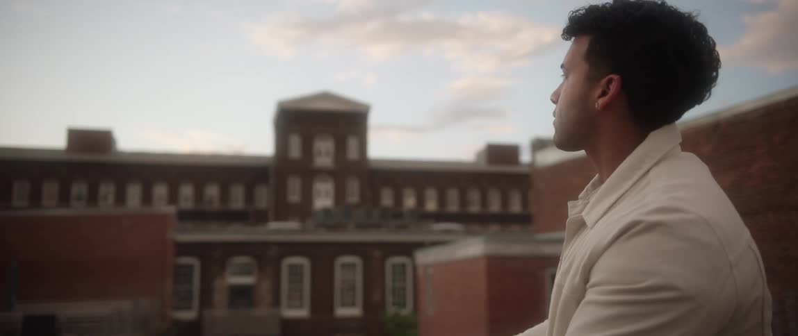 A man is sitting in a downtown city