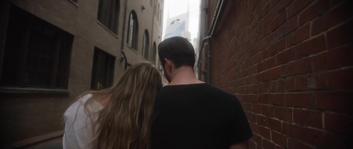Boyfriend and girlfriend are walking through an alley together
