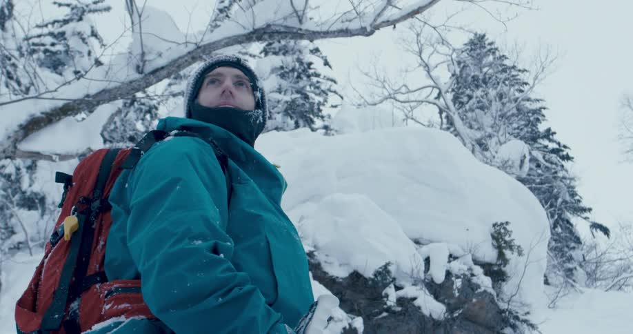 A man is walking outdoors in winter