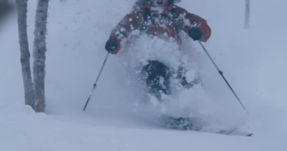A man is skiing in the winter during the day