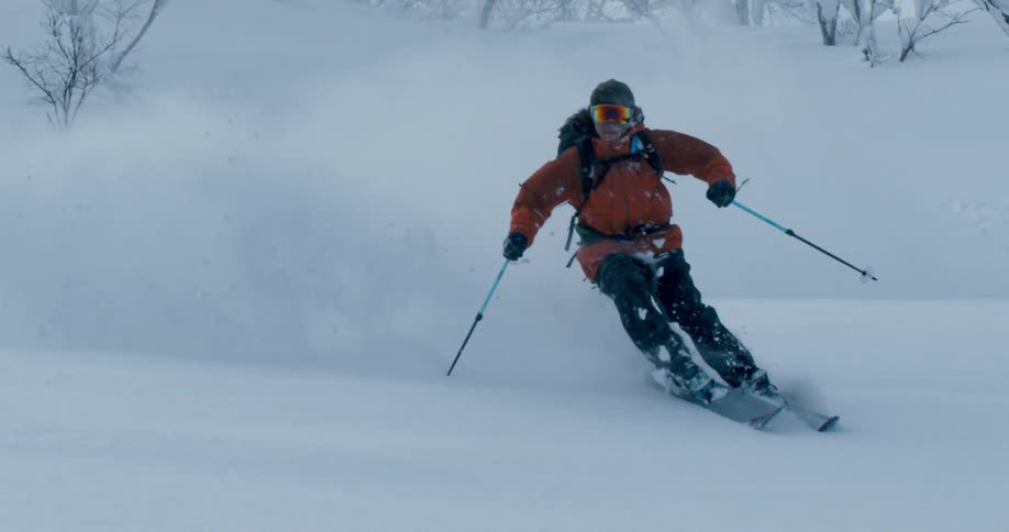 A man is skiing outdoors in winter