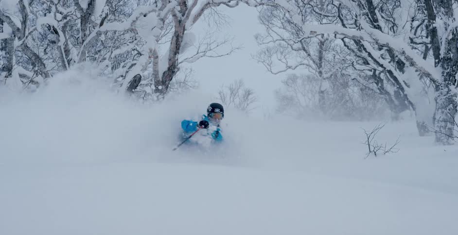 A man is skiing in winter during the day