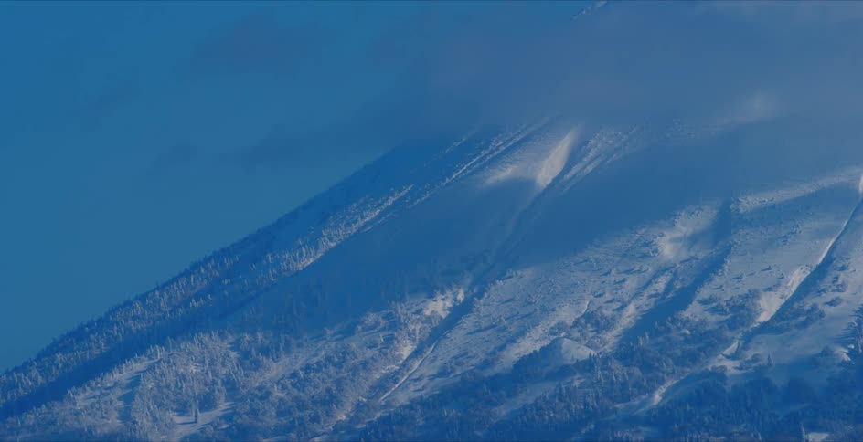Aerial view of snow covering the mountains is displayed