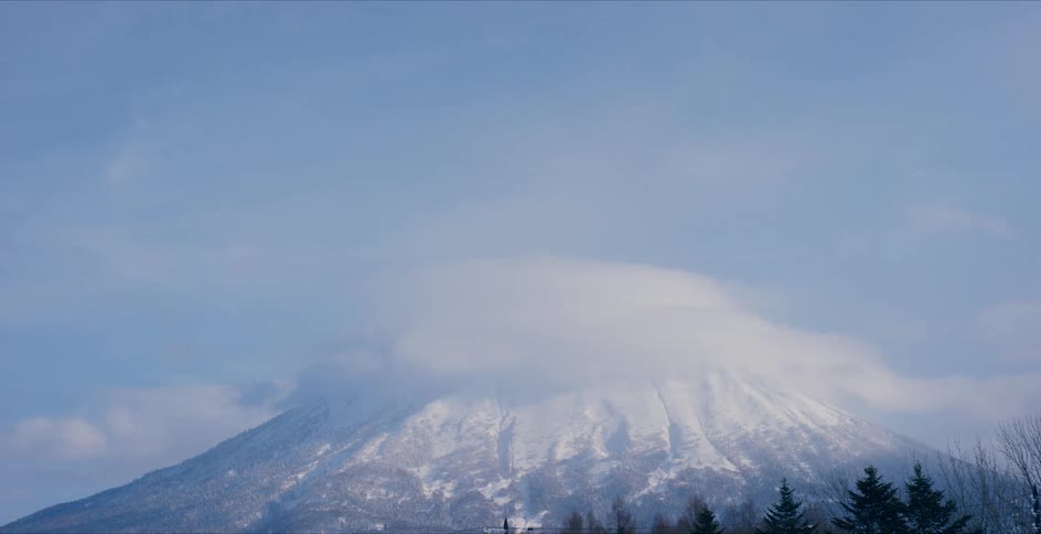 Aerial view of a mountain is displayed during the day
