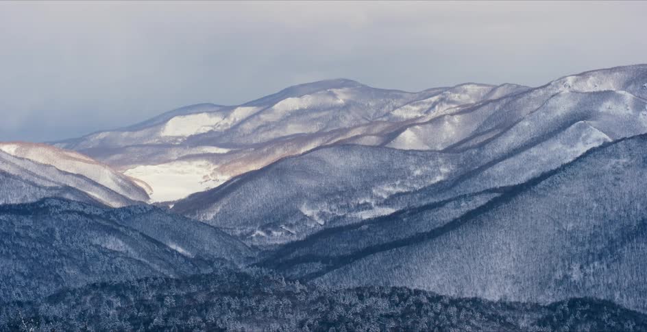 Aerial view of snow covered mountains is displayed