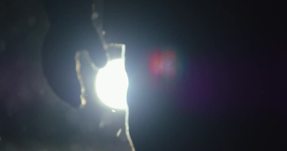 Moonlight shows a person walking in a snow storm on a dark night