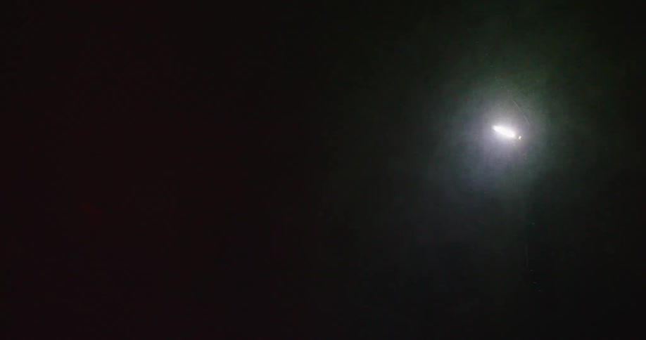 Frost outdoors is visible in front of a lamp post at night