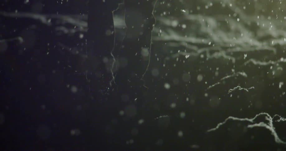 A person walking on snow as snow falls