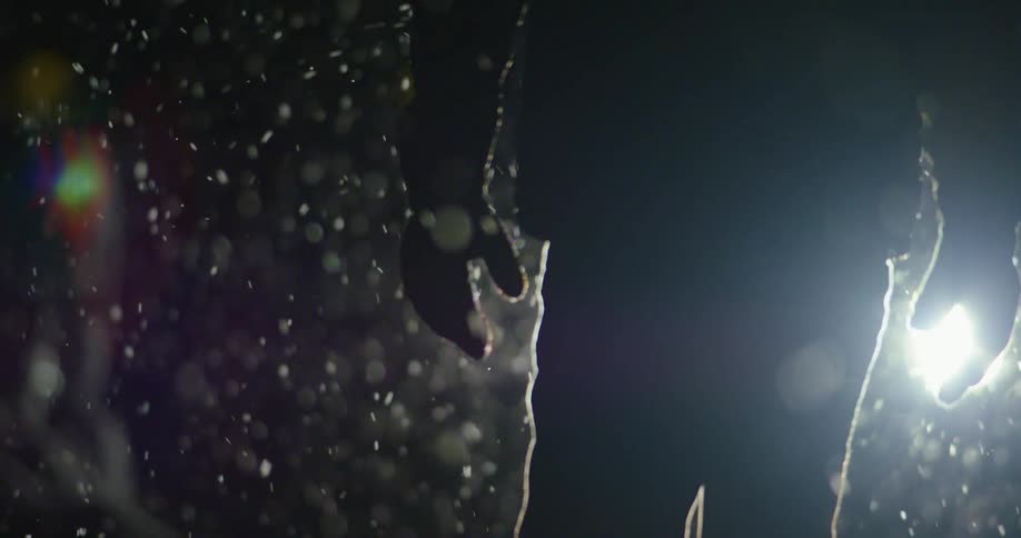 A man walking outside in the snow at night