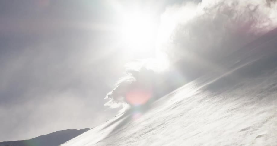 Person wipes out while skiing downhill in mountains