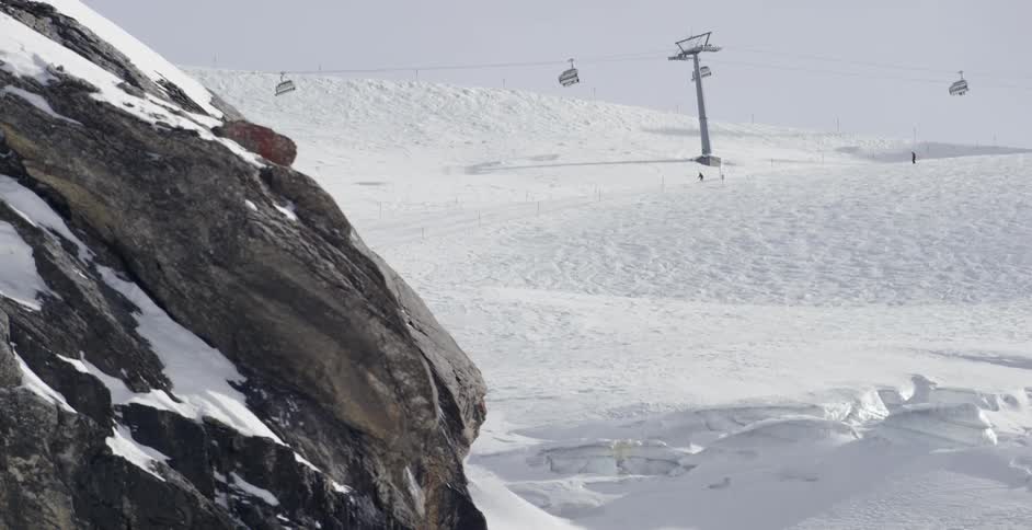 Skiers on a snowy mountain and people on a ski lift
