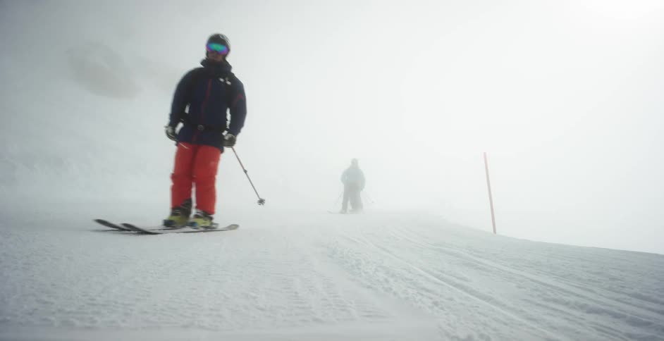 A group of people ski on a snow packed landscape