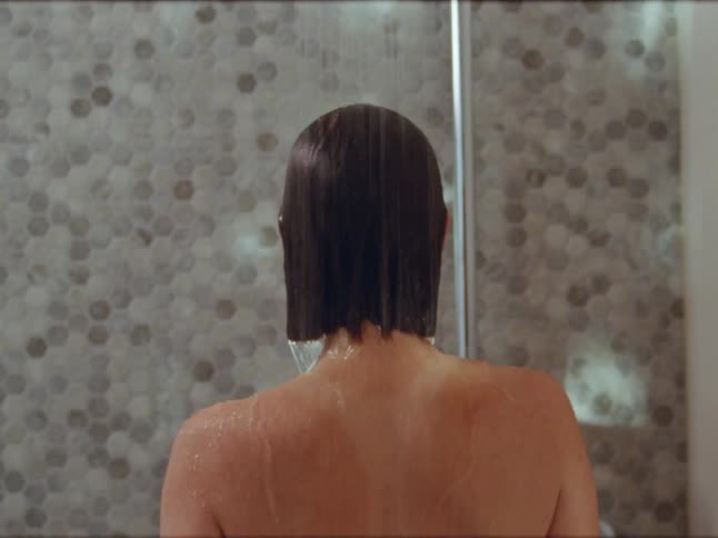 A woman is taking a shower in a bathroom