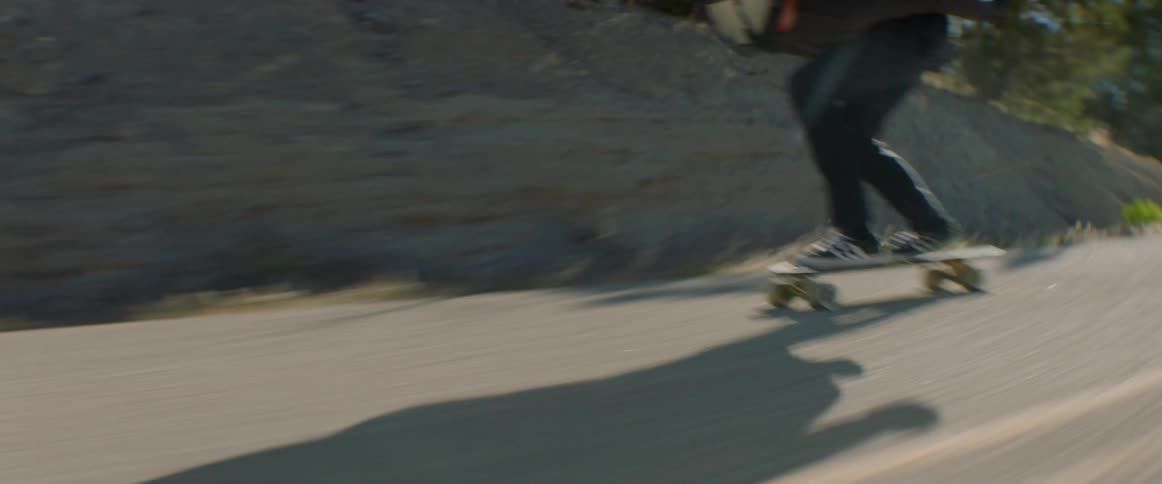 Skateboard rider pushes himself down the street