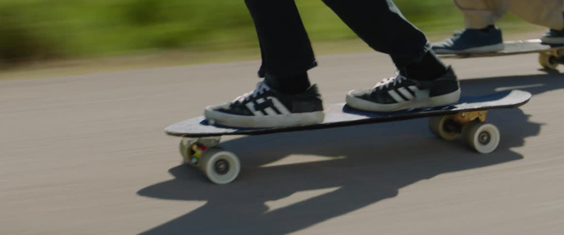 People are racing on skateboards on the road