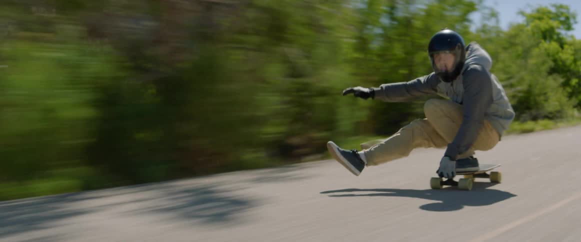 A group of people long boarding down a mountain
