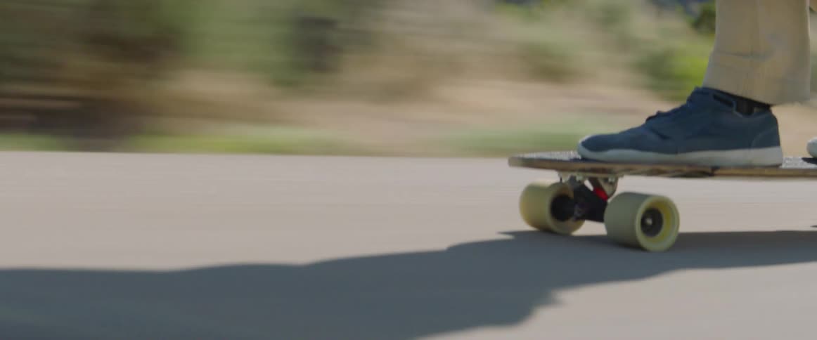 A group of people skateboarding down a mountain