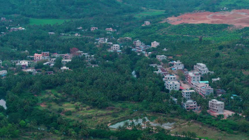 Houses in Hainan, China are surrounded by tropical jungle